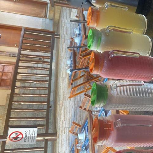 a bunch of water bottles lined up on a wall at La Luna dos Pireneus - Pousada in Pirenópolis