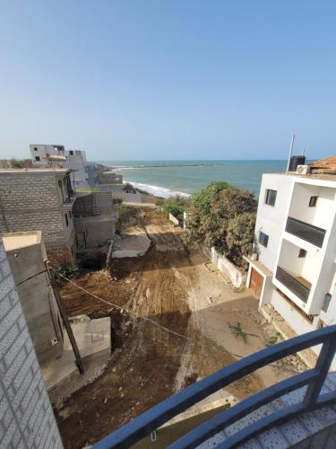 a view of the beach from the balcony of a building at La Holland in Toubab Dialaw