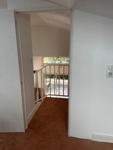 an empty room with an open door to a balcony at Un moment de répit avec massages en Pic St loup in Claret