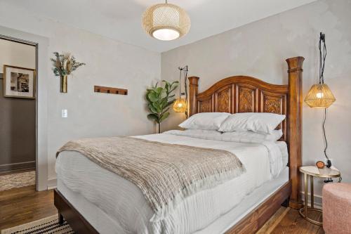 a bedroom with a large bed with a wooden headboard at Peri Social House in Black Mountain