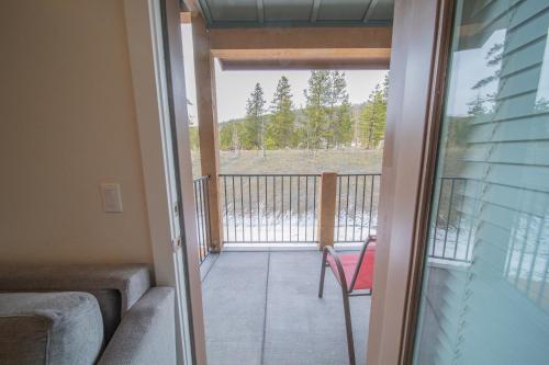 a view from the balcony of a house with a chair at Clearwater Lofts Bldg 3 103 by SummitCove Lodging in Keystone