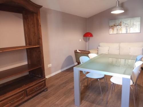 a living room with a table and a couch at Apartamentos "Casa Melé" 3 in Lleida