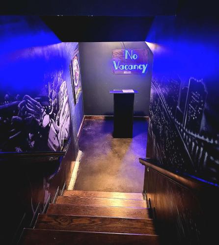a stage with a no vacancy sign and stairs at Aiden San Antonio Riverwalk in San Antonio