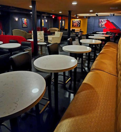 a restaurant with tables and chairs and a couch at Aiden San Antonio Riverwalk in San Antonio