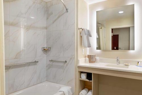 a bathroom with a shower and a sink at Best Western Plus Crossroads Inn & Suites in Zion Crossroads