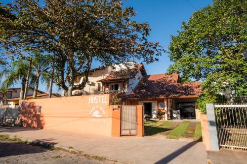 a house with a gate in front of it at Take it Easy Hostel in Florianópolis