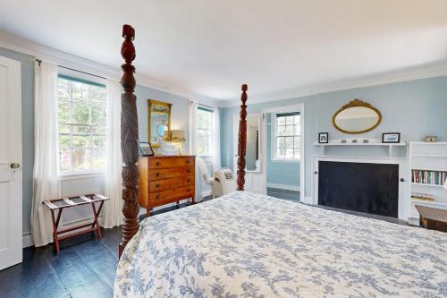 a bedroom with a canopy bed and a fireplace at Nickels-Sortwell House in Wiscasset