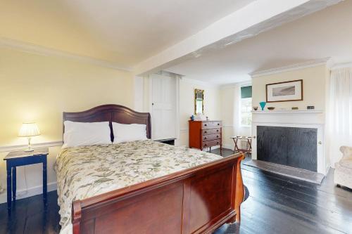 a bedroom with a large bed and a fireplace at Nickels-Sortwell House in Wiscasset