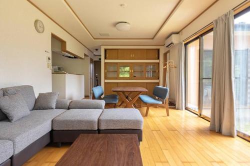 a living room with a couch and a table at ENOKIYA Nikko in Nikko