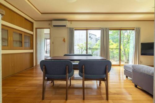 a dining room with a table and two chairs at ENOKIYA Nikko in Nikko