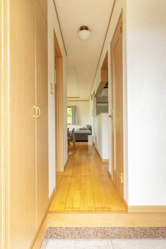a hallway with an open door to a living room at ENOKIYA Nikko in Nikko