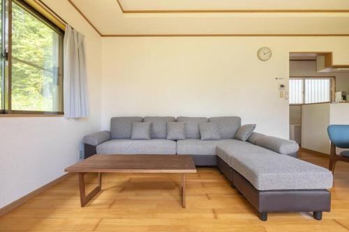 a living room with a couch and a table at ENOKIYA Nikko in Nikko