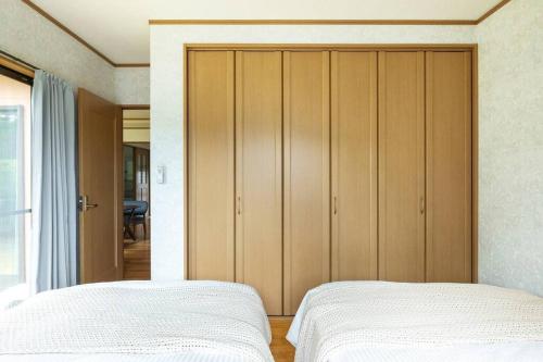 a bedroom with two beds and a large closet at ENOKIYA Nikko in Nikko