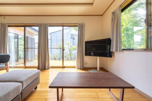 a living room with a couch and a coffee table at ENOKIYA Nikko in Nikko
