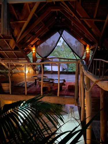 a room with a tent with a table in it at La Bohème Boutique Glamping in General Luna