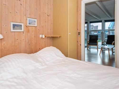 a bedroom with a bed and a table and chairs at 6 person holiday home on a holiday park in Hemmet in Hemmet