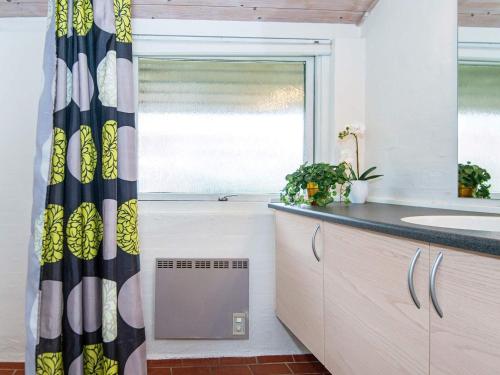 a bathroom with a sink and a window at 6 person holiday home on a holiday park in Hemmet in Hemmet