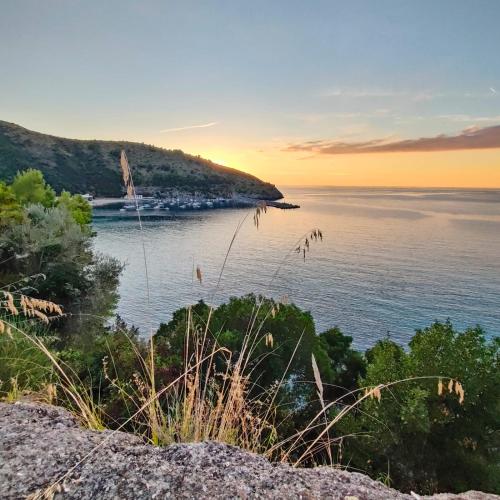 a view of a body of water at sunset at Sweet home Palinuro in Palinuro