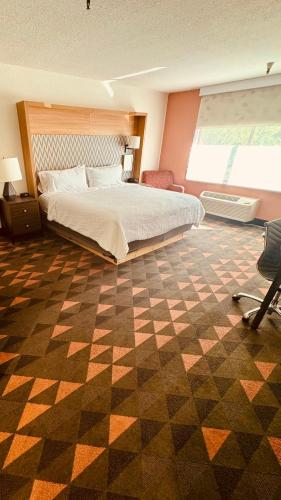 a bedroom with a bed and a checkered floor at Holiday Inn Rancho Cordova - Northeast Sacramento by IHG in Rancho Cordova