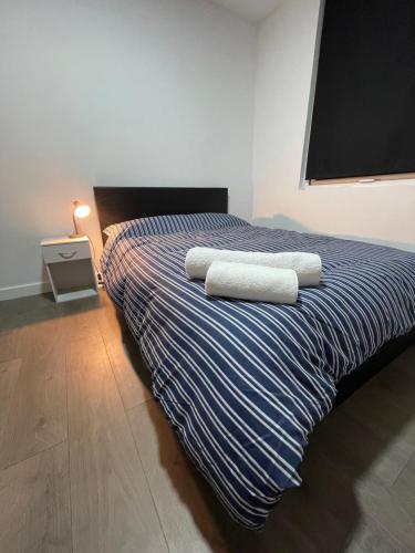 a bedroom with a bed with two towels on it at Galway Suite in Preston