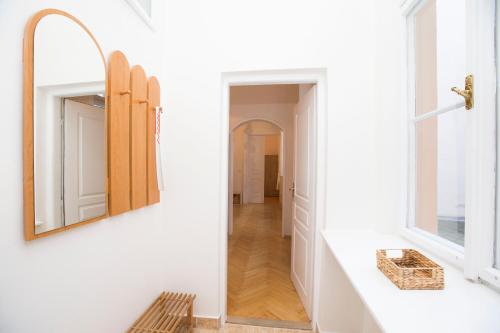 a bathroom with a mirror and a hallway at Greg Apartments Kampa Prague in Prague