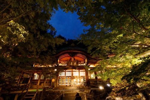 a building is lit up at night at Kamei no Yu in Yamanouchi