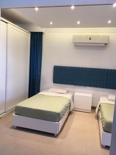 a bedroom with two beds and a wall with a heater at Tallinn Travel in Sharm El Sheikh