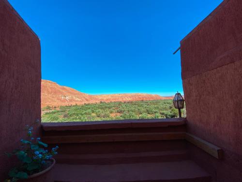 a view from a balcony with a view of a field at Auberge Ayouze in Aït Ben Haddou
