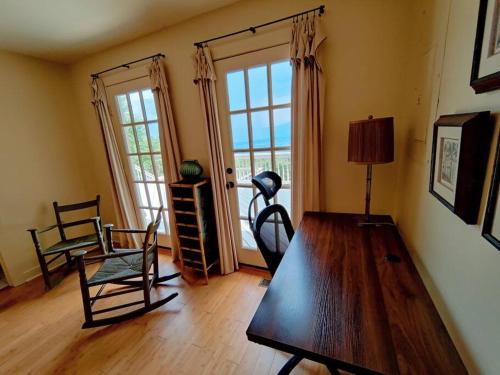 a living room with a wooden table and chairs at Paradise View Cabin on Massanutten Mountain in Luray