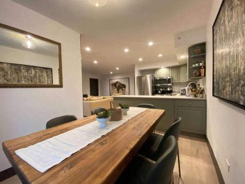 a kitchen with a wooden table and some chairs at 3Bdr in the heart of lions head Ski locker in Vail