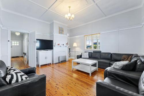 a living room with a couch and a table at The Seamist Cottage in Narooma
