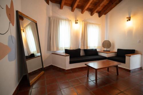 a living room with a couch and a table at Hanna Hotel Boutique in Valle de Bravo
