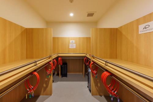 a row ofabinets in a gym with red chairs at WeBase Hiroshima in Hiroshima
