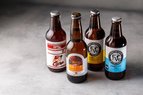 four bottles of beer sitting next to each other at WeBase Hiroshima in Hiroshima
