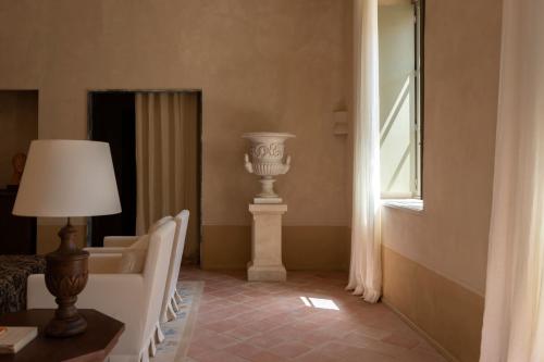 a room with a column and a lamp and a window at Hôtel du Couvent, a Luxury Collection Hotel, Nice in Nice