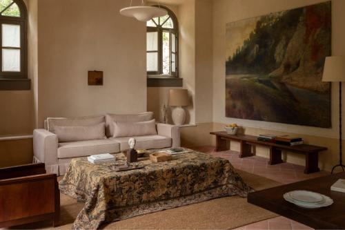 a living room with a couch and a table at Hôtel du Couvent, a Luxury Collection Hotel, Nice in Nice