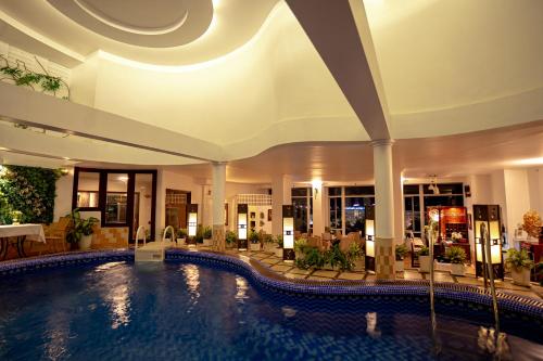 a hotel swimming pool in the middle of a building at Asia Hotel Hue in Hue