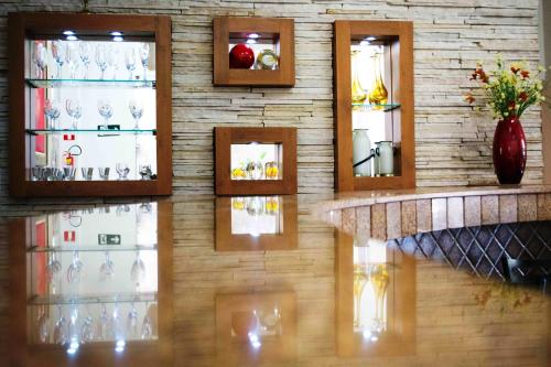 a wall of wine glasses in a room at Presidente Hotel in Poços de Caldas