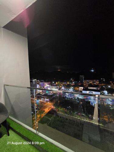 a view of a city at night from a balcony at The Shore Home Suites Kota Kinabalu City Sabah Center in Kota Kinabalu