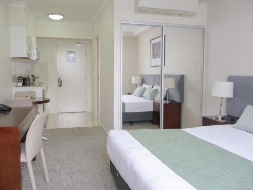 a hotel room with a bed and a bathroom at Quest Breakfast Creek in Brisbane