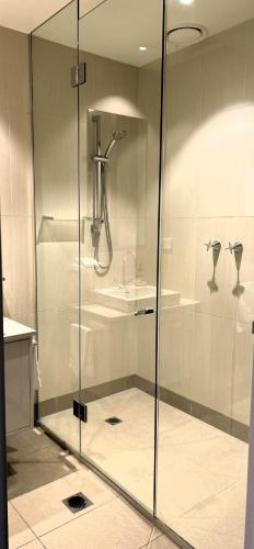 a shower with a glass door in a bathroom at PIER POINT 3 Bedroom Apartment with Bay Views on the Geelong Waterfront - 801 in Geelong