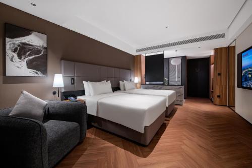 Ένα ή περισσότερα κρεβάτια σε δωμάτιο στο Intercity Hotel Guangzhou East Railway Station - registration counter for Overseas buyers & Free Shuttle Bus During Canton Fair Period