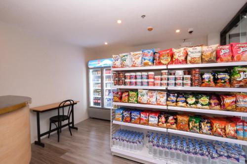 a store aisle with a display of food and drinks at The Quarters by Rosey in Cabanatuan