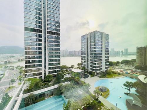 an aerial view of two tall buildings with a pool at Slow Cloud Residence - Gongbei Port Zhuhai Station in Wan-tzu