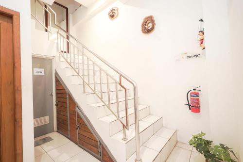 a staircase in a house with white walls at Cabin Hotel Ringroad Utara in Seturan