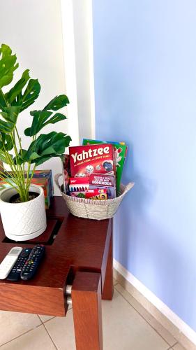 a table with a remote control and a plant on it at Charming and Family With a pool and ocean view, 3 blocks from the beach, with 2 TVs and Netflix in Boca del Río