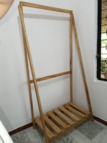 a wooden shelf in a corner of a room at Casa la Estancia 2 in Tena