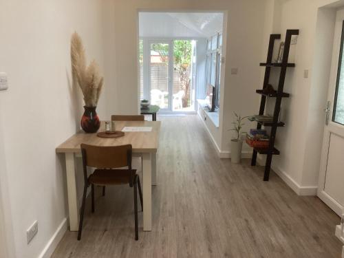 a dining room with a table and chairs at Forest Heath Holidays - The Nook in Ringwood