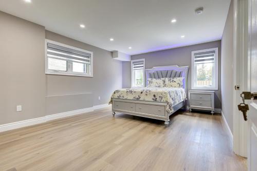 a bedroom with a bed and two windows at New Furnished 1bedroom basement in Waterloo