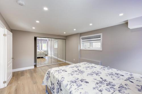 a bedroom with a bed with a blue and white blanket at New Furnished 1bedroom basement in Waterloo